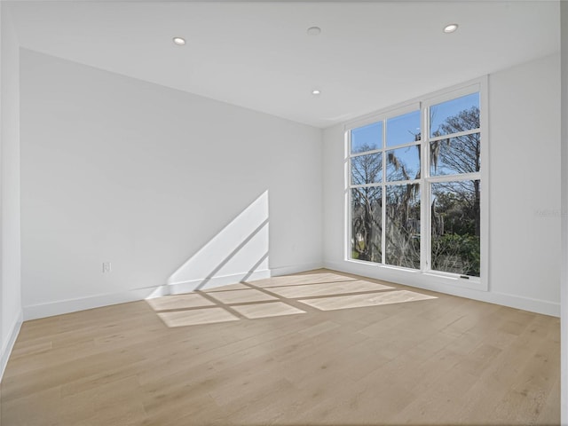 empty room with light hardwood / wood-style flooring