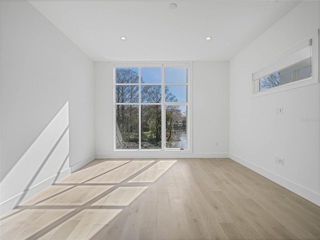 spare room with light hardwood / wood-style floors