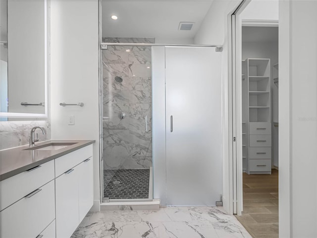 bathroom with vanity and an enclosed shower