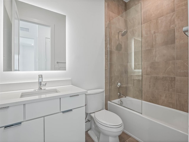 full bathroom with tile patterned floors, toilet, vanity, and tiled shower / bath