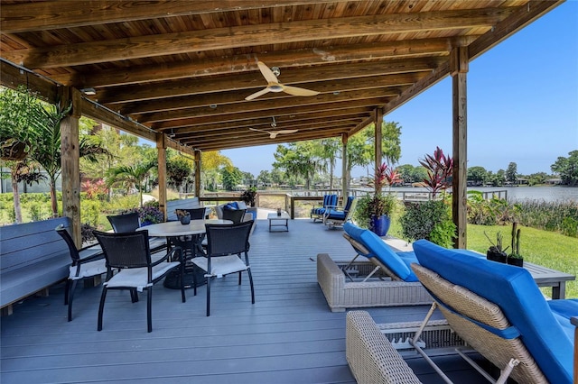 deck with ceiling fan, a water view, and an outdoor hangout area