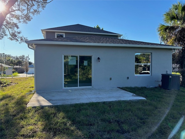 back of house with a yard, a patio, and central air condition unit