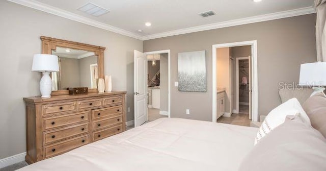 bedroom with ornamental molding and ensuite bath