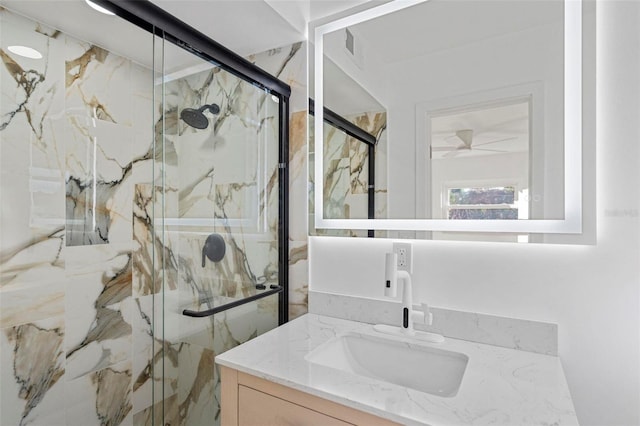 bathroom featuring vanity and an enclosed shower