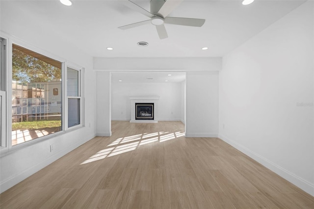 unfurnished living room featuring light wood-type flooring and ceiling fan