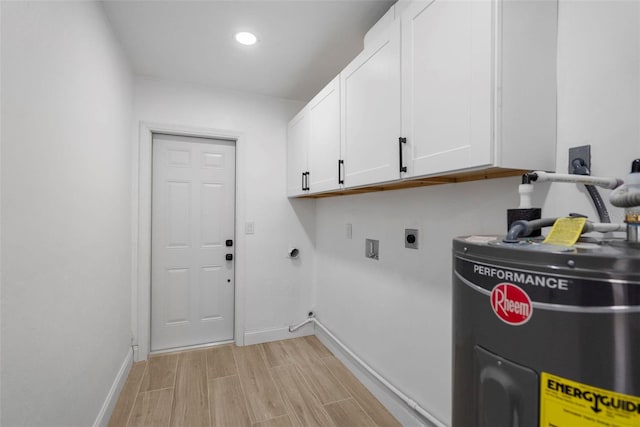 washroom featuring electric dryer hookup, electric water heater, hookup for a washing machine, and cabinets