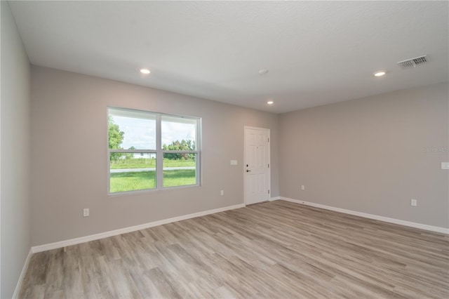 unfurnished room with light wood-type flooring