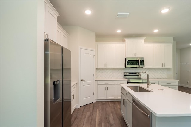 kitchen featuring white cabinets, visible vents, stainless steel appliances, and light countertops