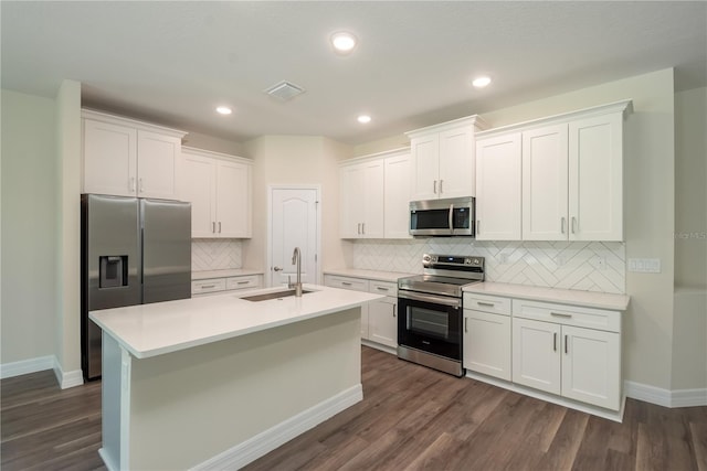 kitchen featuring stainless steel appliances, white cabinets, a sink, and visible vents