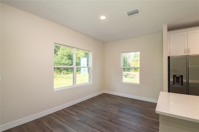 interior space with plenty of natural light, baseboards, and visible vents