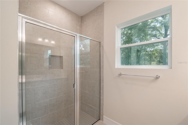 bathroom with a tile shower