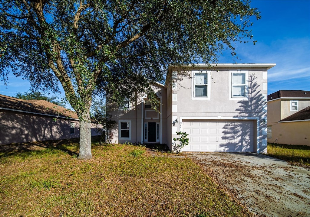 view of front of home featuring a front yard and a garage