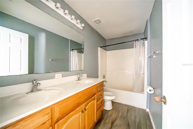 full bathroom featuring toilet, hardwood / wood-style floors, vanity, and shower / tub combo with curtain