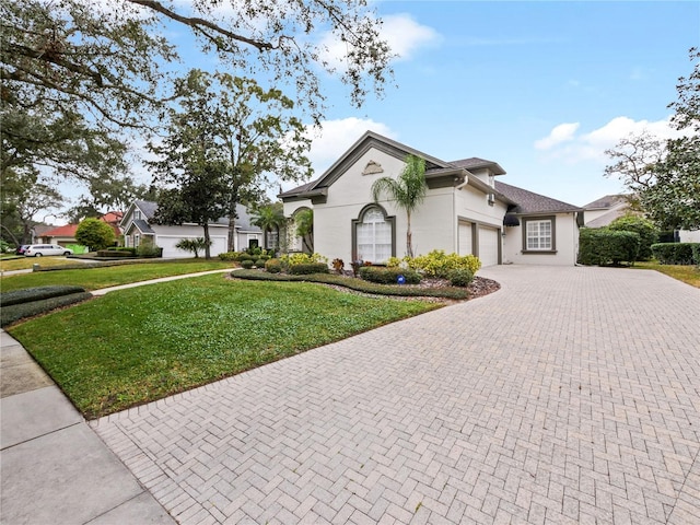 mediterranean / spanish-style home with a front yard and a garage