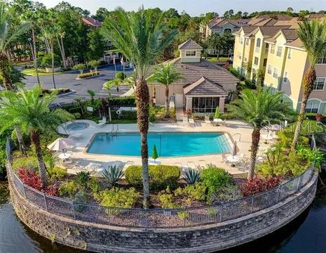 view of swimming pool featuring a water view and a patio