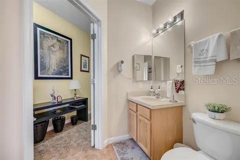 bathroom featuring vanity and toilet