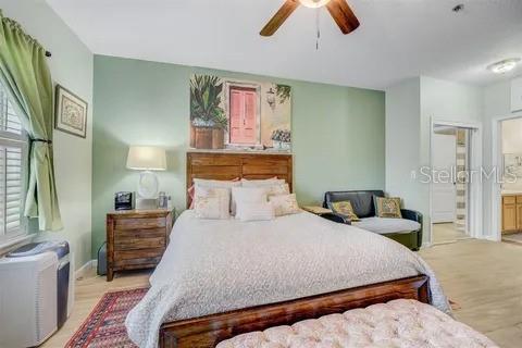 bedroom with ensuite bath and ceiling fan