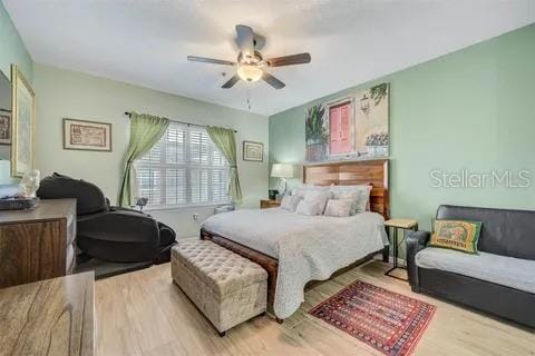 bedroom with ceiling fan and light hardwood / wood-style floors