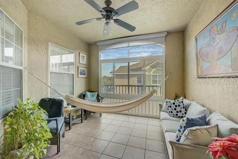 sunroom / solarium featuring ceiling fan