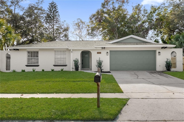 single story home featuring a garage and a front lawn