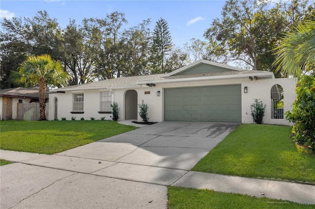 ranch-style home featuring a garage and a front lawn