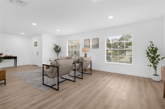 living room featuring a wealth of natural light and light hardwood / wood-style flooring