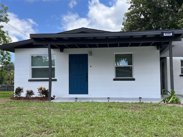 view of front of house with a porch and a front lawn