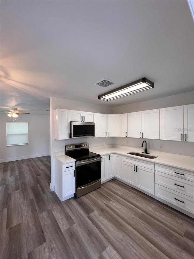 kitchen featuring white cabinetry, sink, and appliances with stainless steel finishes