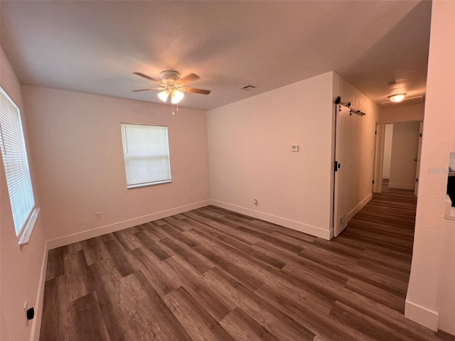 empty room featuring ceiling fan and dark wood-type flooring