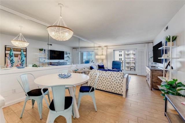 dining area featuring a chandelier and light hardwood / wood-style floors