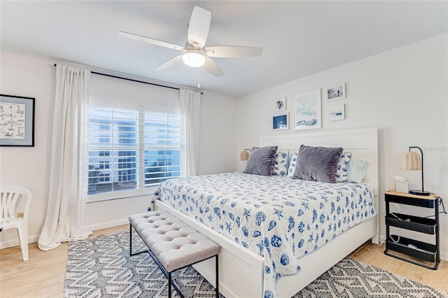 bedroom with light hardwood / wood-style flooring and ceiling fan