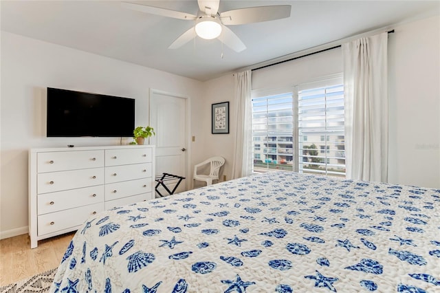 bedroom with ceiling fan and light hardwood / wood-style flooring