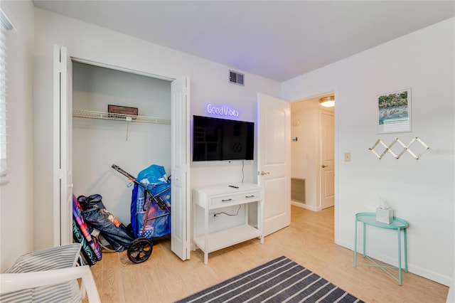 bedroom with a closet and hardwood / wood-style flooring