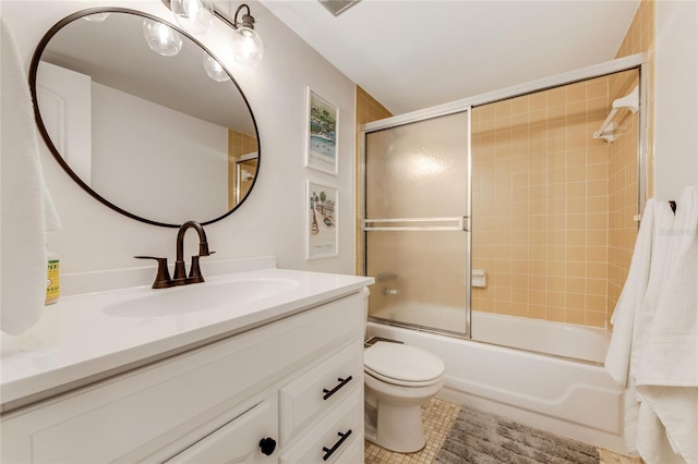 full bathroom featuring tile patterned flooring, vanity, toilet, and bath / shower combo with glass door