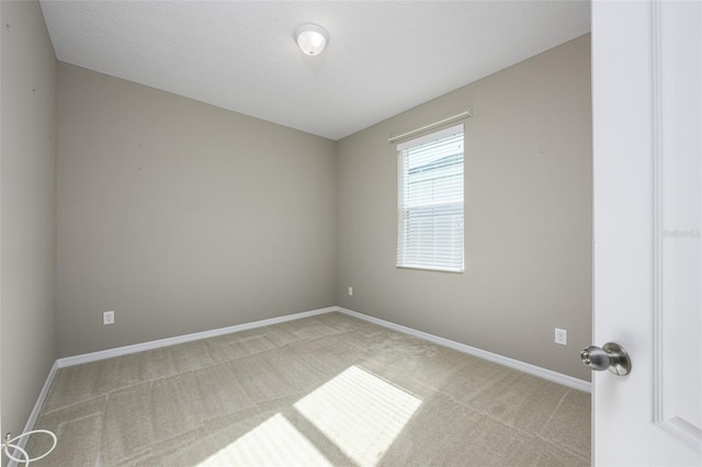 carpeted empty room featuring a textured ceiling