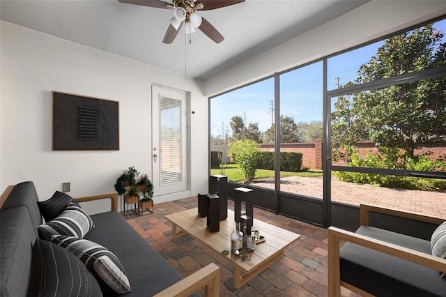 sunroom featuring ceiling fan and a healthy amount of sunlight