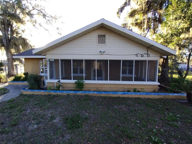 back of house with a sunroom