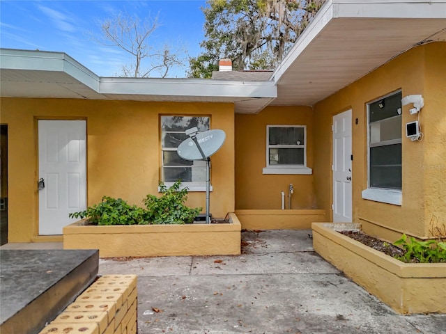 property entrance featuring a patio area