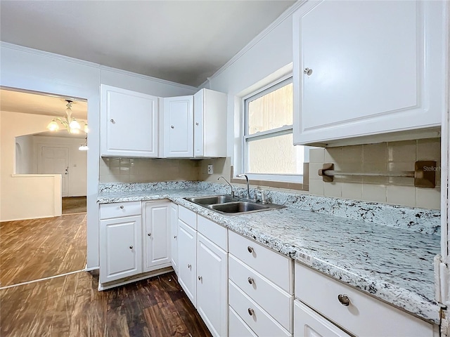 kitchen featuring tasteful backsplash, sink, dark wood-type flooring, and white cabinets