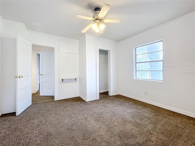 unfurnished bedroom with ceiling fan, crown molding, and dark carpet