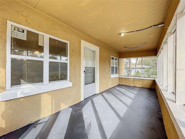 unfurnished sunroom featuring wooden ceiling