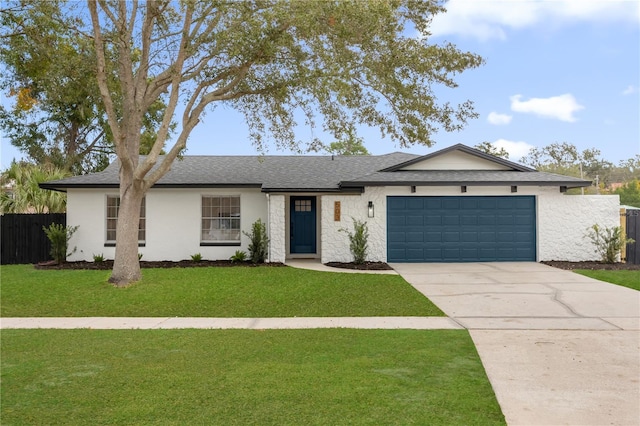 ranch-style home featuring a front yard and a garage