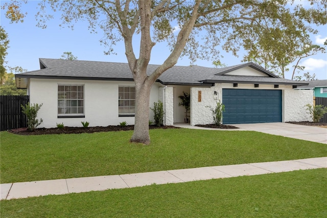 ranch-style house featuring a front yard and a garage