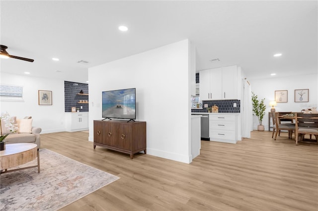 living room featuring ceiling fan and light hardwood / wood-style floors