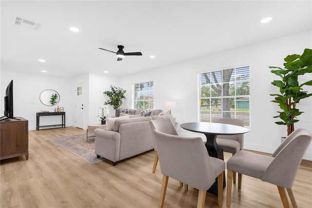 dining area with light hardwood / wood-style flooring and ceiling fan