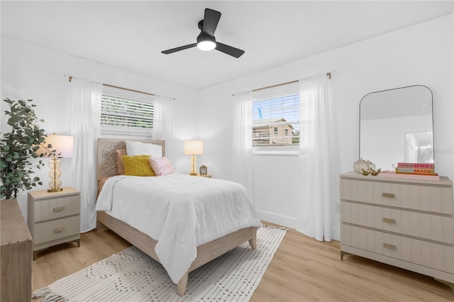 bedroom with ceiling fan and light hardwood / wood-style flooring