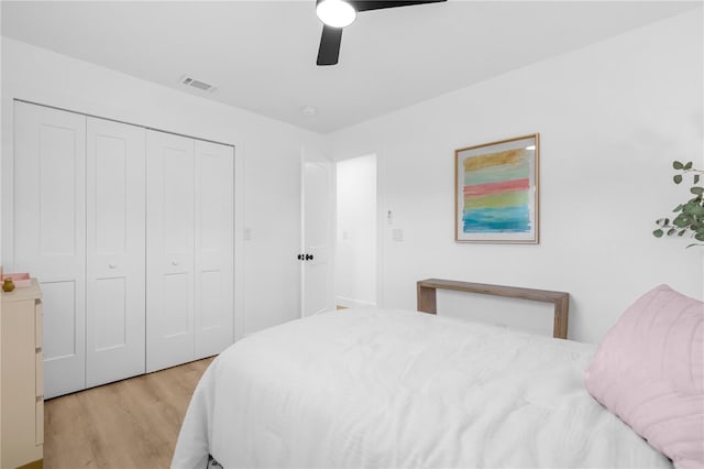 bedroom with ceiling fan, a closet, and light wood-type flooring