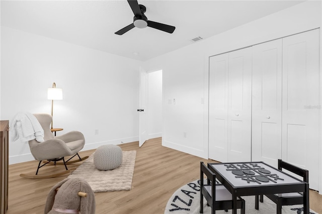 living area featuring ceiling fan and light hardwood / wood-style flooring