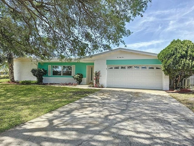 ranch-style house featuring a garage and a front yard