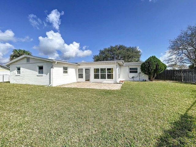 rear view of property with a patio area and a yard